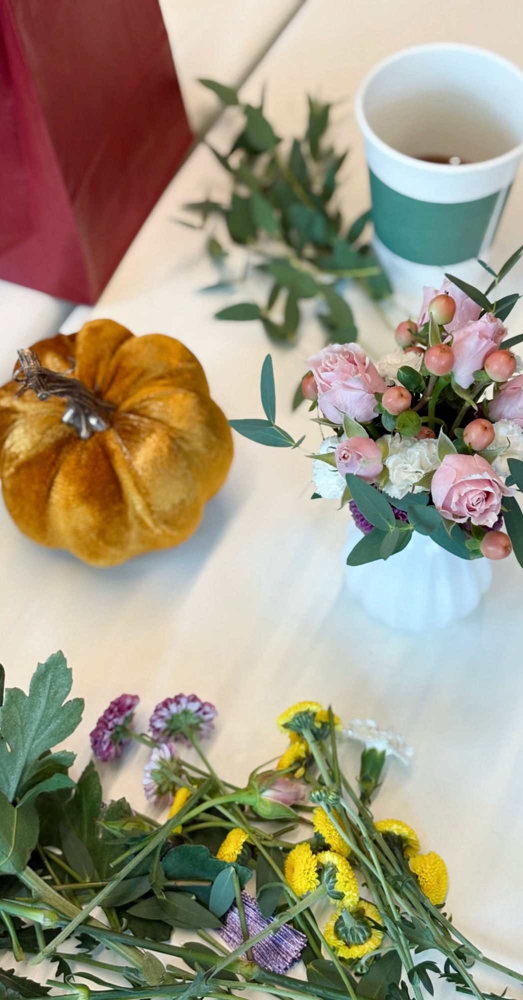 Floral arrangement in progress with fall decor